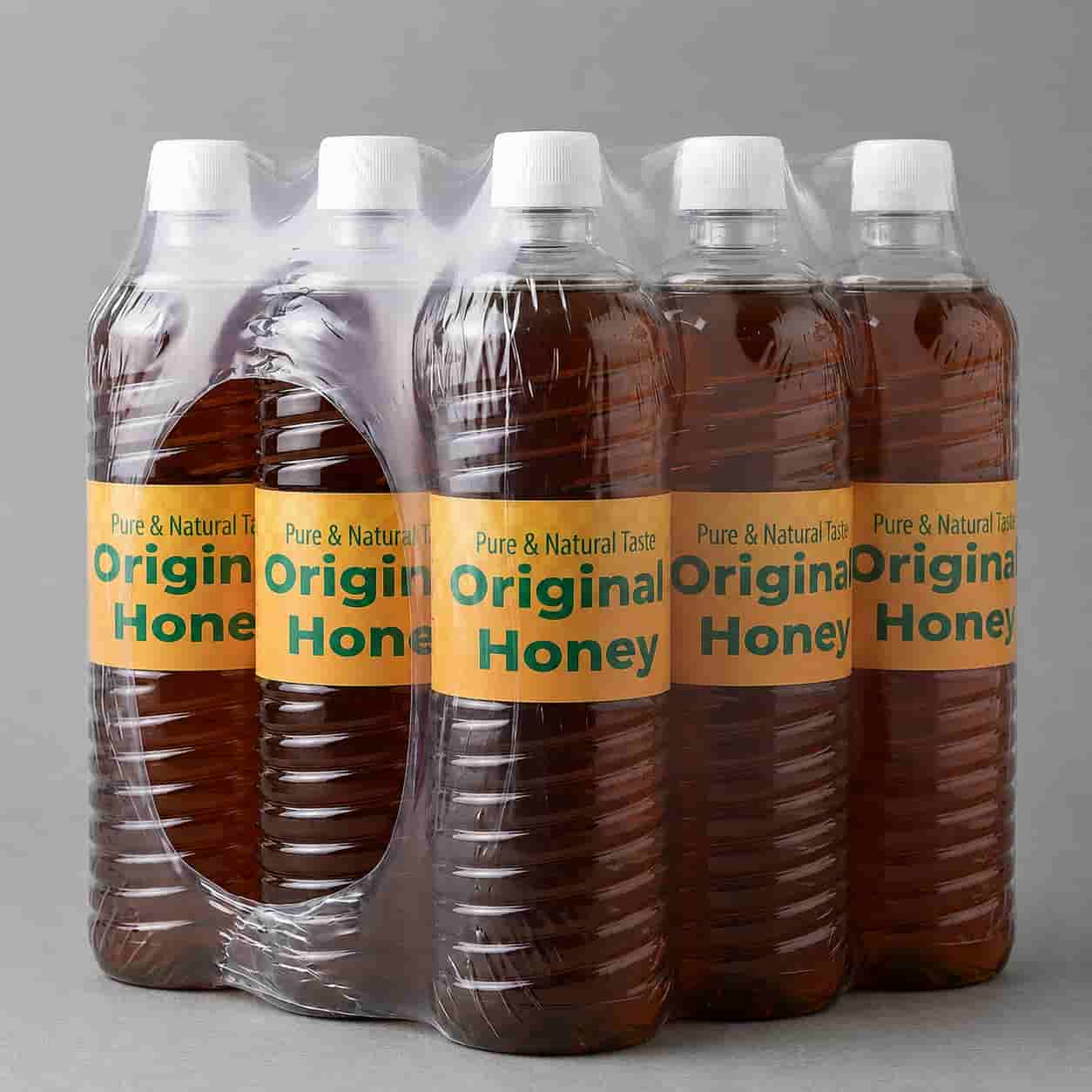 Original honey in a clear plastic bottle with a golden label