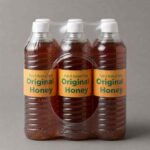 Original honey in a clear plastic bottle with a golden label