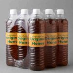 Original honey in a clear plastic bottle with a golden label